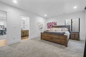 Carpeted bedroom with recessed lighting, baseboards, and connected bathroom