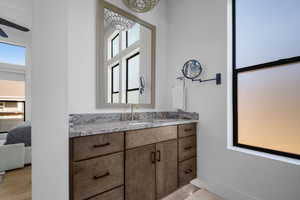 Bathroom featuring plenty of natural light, vanity, and connected bathroom