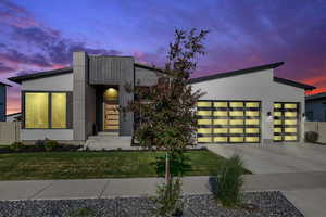 Modern home featuring an attached garage and driveway