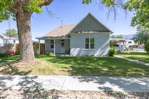 View of front facade with stucco siding, a mountain view, and roof with shingles
