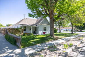 View of front of house with stucco siding and a shingled roof
