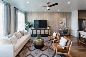 Living room featuring wood finished floors, recessed lighting, ceiling fan, and baseboards
