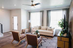 Living room featuring wood finished floors, ceiling fan, baseboards, and recessed lighting
