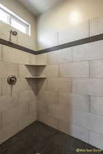 Full bath featuring tiled shower