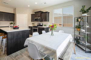 Dining space with light wood-type flooring, recessed lighting, and baseboards