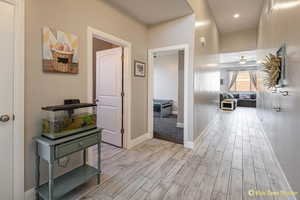 Hallway featuring light wood-style floors and baseboards