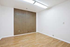 Spare room featuring light wood finished floors and baseboards