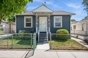 Bungalow-style house featuring roof with shingles