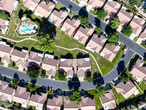 Aerial overview of property's location featuring nearby suburban area and a pool