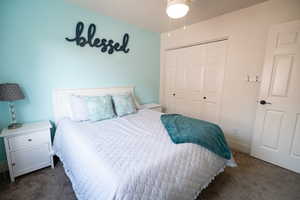 Bedroom with carpet floors, a closet, and baseboards
