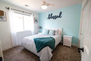 Bedroom with a closet, carpet, and baseboards