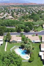 Aerial view of residential area featuring a pool area and mountains