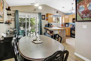 Dining space featuring light wood-style floors and lofted ceiling