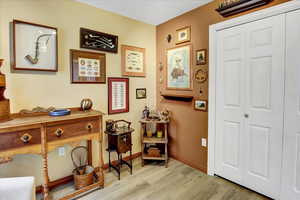 Living area with light wood-style flooring and baseboards