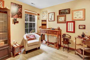 Living area featuring light wood-type flooring and baseboards