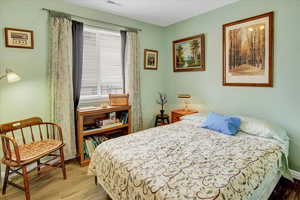Bedroom featuring light wood-style floors and baseboards