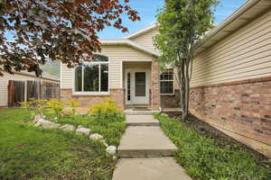Entrance to property featuring brick siding