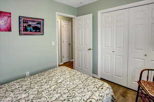 Bedroom with a closet and wood finished floors