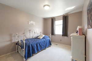 Carpeted bedroom featuring baseboards