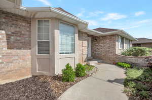 Doorway to property with brick siding