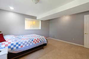 Bedroom with light carpet and baseboards