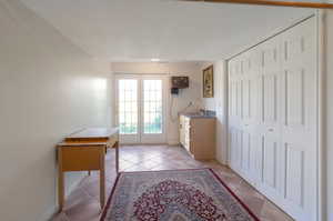 Entryway with light tile patterned floors and baseboards