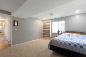 Carpeted bedroom with baseboards and recessed lighting