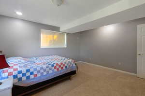 Bedroom featuring carpet flooring and baseboards