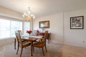 Dining space with a chandelier, plenty of natural light, and baseboards