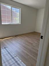 Spare room with wood finished floors and baseboards