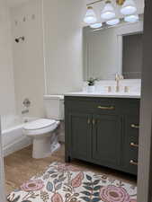 Full bath with wood finished floors, vanity, toilet, and shower / washtub combination