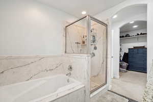 Primary Full bath with a bath, a marble finish shower, a spacious closet, and recessed lighting