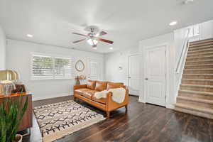 Living area featuring stairway, a ceiling fan, wood finished floors, recessed lighting, and baseboards