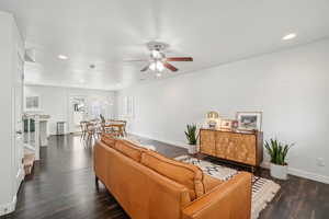 Living area with ceiling fan, baseboards, recessed lighting, and dark wood finished floors