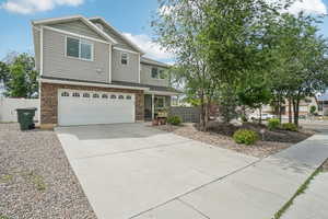 View of front of home featuring a garage, concrete driveway, RV Parking and stone siding