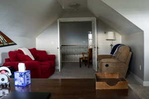 Bonus room with lofted ceiling, carpet flooring, and baseboards