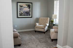 Small sitting room featuring carpet flooring and baseboards