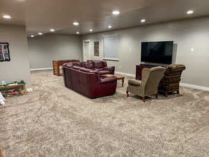 Living room with carpet floors, recessed lighting, and baseboards