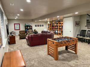 Recreation room with carpet floors and recessed lighting
