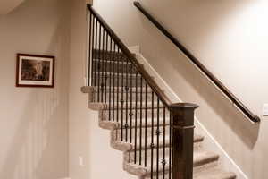 Stairway featuring baseboards to the basement.