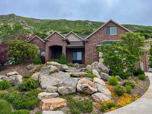 Traditional-style home with brick siding and a mountain view