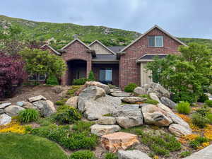 Traditional-style home featuring brick siding, a mountain view, and a shingled roof
