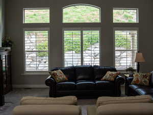 Carpeted living area featuring baseboards