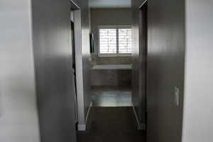 View of hall to the bathroom with closets on each side.