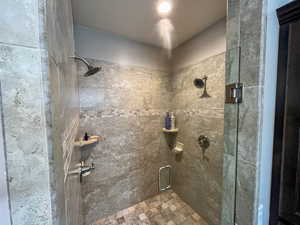 Full bath featuring a shower stall