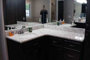 Ensuite bathroom featuring vanity, a garden tub, and a shower
