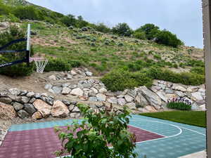 View of basketball court featuring basketball hoop