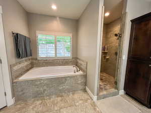 Full bath with a bath, a shower stall, and recessed lighting
