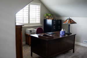 Office area with carpet floors, lofted ceiling, and baseboards