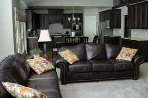 Living area featuring carpet floors and a chandelier
